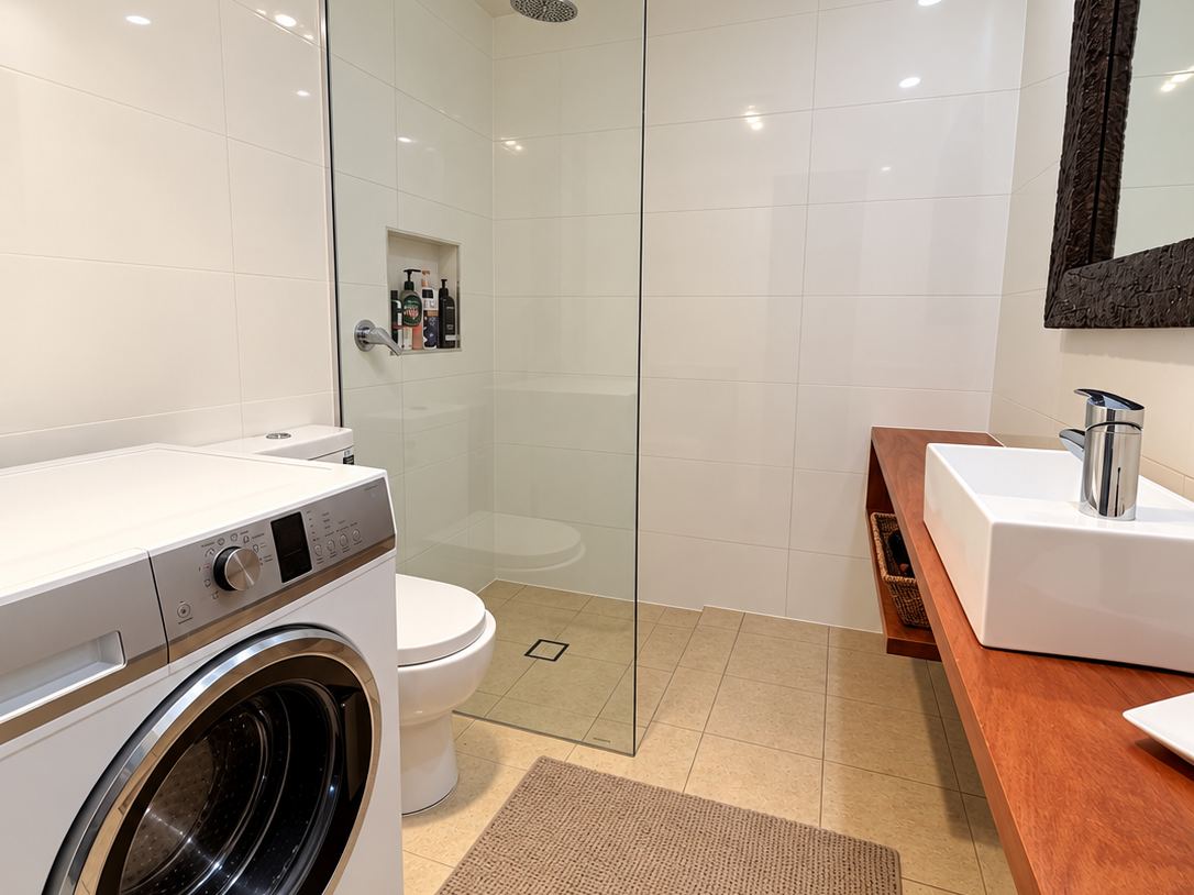 Bathroom with rain shower, laundry and timber vanity at Sandy Feet Retreat