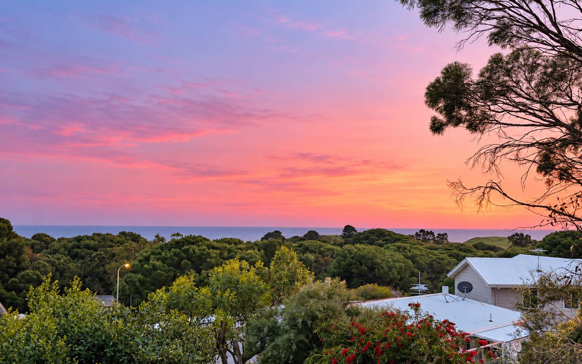 Pink dusk sky over Second Valley rooftops and the sea